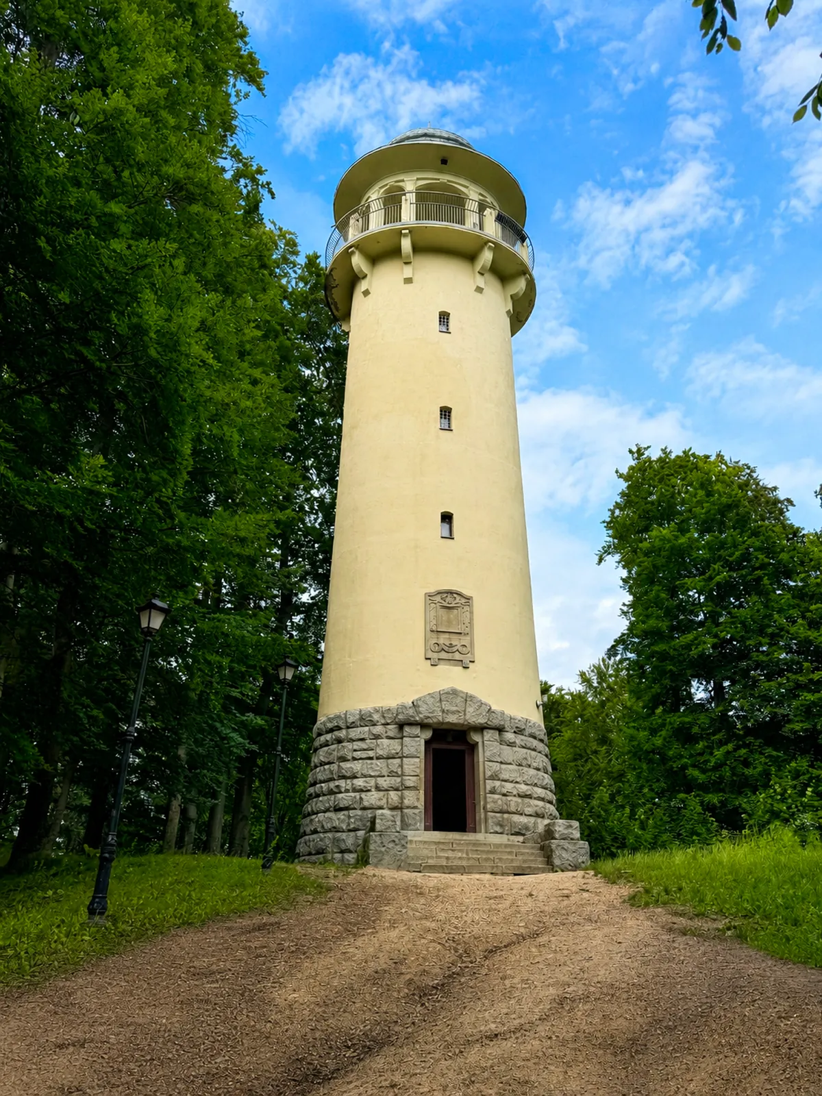 Wieża widokowa Grzybek na Wzgórzu Krzywoustego – jasna cylindryczna wieża z metalowym hełmem wśród drzew